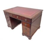 A late 19th to early 20th century oak pedestal desk: the red morocco gilt-tooled inset moulded top