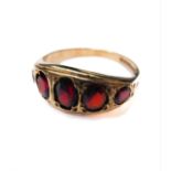 A 9-carat gold ring set with five graduated garnets, ring size S
