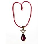 A 9-carat gold pendant set with a large red stone