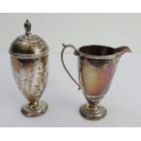A hallmarked silver caster of baluster form and a hallmarked silver cream jug (combined weight 176