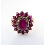 A 9 carat gold ring set with rubies and diamonds. size M