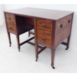 An unusual late 18th/early 19th century George III period mahogany writing desk; the reeded slightly