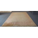 A large Chinese beige ground woollen carpet with rose pink border: cut at one end to accommodate a