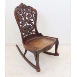 An unusual 19th century continental mahogany rocking chair: the pierced back with scrolling acanthus