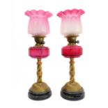 A fine and rare pair of 19th century brass, marble and cranberry glass oil lamps: the crimped-edge