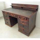 A late 19th/early 20th century oak desk: galleried back, Rexine-insert moulded top and an