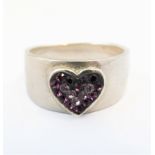 A bespoke silver ring set with hand-cut amethyst and pink stones set in a heart shaped design in