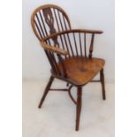 A mid-19th century fruitwood Windsor chair: pierced splat and spindle back above a shaped bow and