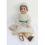 A large bisque head sleeping-eyes doll by Simon and Halbig: pierced ears and composition body;