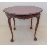 An early 20th century circular mahogany centre table; the slightly overhanging gadrooned edge