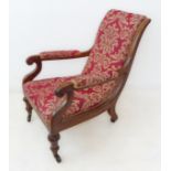 A late Regency period upholstered and mahogany open armchair: the arms terminating in lappet scrolls