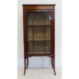 An Edwardian mahogany and boxwood-strung display cabinet: galleried back above a single glazed