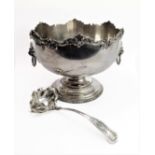 A large, showy and impressive silver-plated punch bowl: foliate cast outer border with C-scrolls and