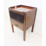 A late 18th century tray-top mahogany commode: two pierced carrying handles above a tambour front