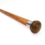 An early 20th century silver collared walking stick with patinated, rounded and figured handle (91.