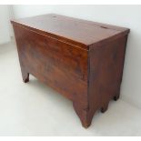 A 19th century stained and polished pine chest: the hinged lid above shaped bracket feet (102.5cm