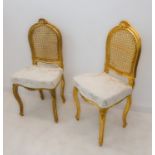 A pair of gilded and damask upholstered bedroom/salon chairs in Louis XV style: cabriole front