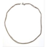 A long designer silver necklace modelled with alternating tube shaped spacers and three spheres (