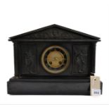 A late 19th century black slate eight-day mantle clock of architectural design: the chapter ring