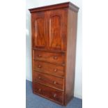 A mid 19th century mahogany cabinet on chest: the cushion moulded cornice above two arched