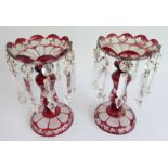 A pair of 19th century red flash-cut table lustres: the shaped tops etched with fruiting vine and