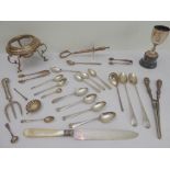 A selection of silver to include: teaspoons, long spoons and sugar tongs; a mother of pearl