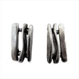 A pair of modern designer silver stud earrings modelled as varying sized/shaped verticals in