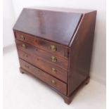 A late 18th century mahogany writing bureau: the angular figured fall opening to reveal a central