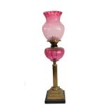 A 19th century brass, marble and cranberry glass oil lamp: the thistle-shaped crimped edge shade