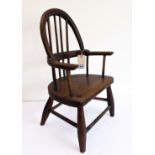 A miniature late 19th/early 20th century Windsor armchair: spindle back, elm bow above a demi-lune