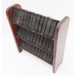 A bookstand set of 40 miniature Shakespeare editions (20 cm wide x 23 cm high)