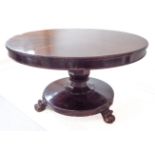 An early Victorian walnut tilt-top breakfast table: faceted baluster-shaped stem; circular