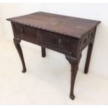 An 18th century oak side table (later carved); the outset top above a single full width drawer