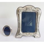 Two modern hallmarked silver photograph frames. The larger example with cushion-style frame