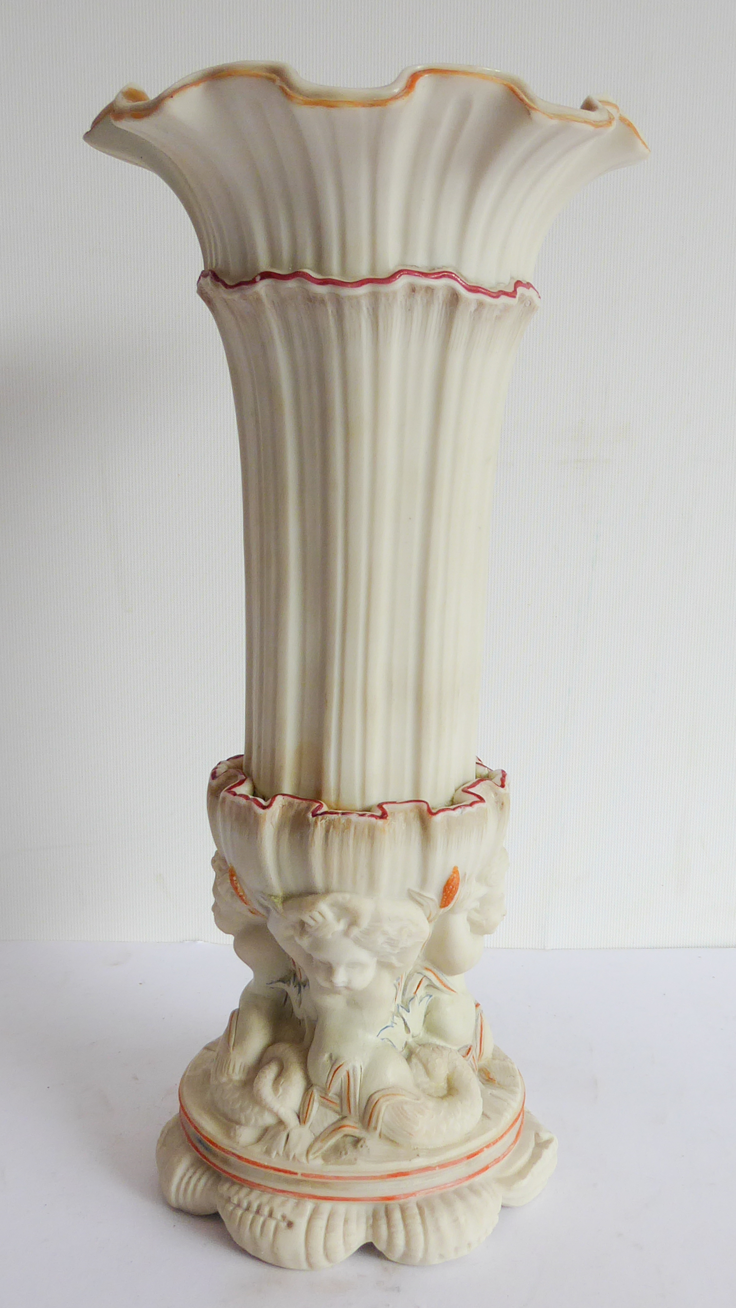 An unusual 19th century Parian ware vase of trumpet form: the gilded flowerhead-shaped top above a