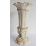 An unusual 19th century Parian ware vase of trumpet form: the gilded flowerhead-shaped top above a