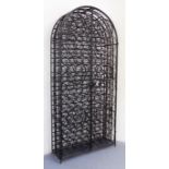 A large and heavy wrought-iron two-door bottle cabinet: with arched top and scrolling decoration (
