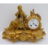 A 19th century gilt-metal eight-day figural mantle clock: the white enamel dial with Roman