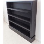 A modern ebonised set of open bookshelves on plinth base (125cm wide x 20cm deep x 122cm high)