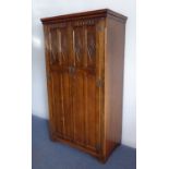 A good reproduction oak two-door wardrobe of slim proportions and good colour: the doors with
