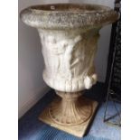 An extremally large and heavy stoneware urn: moulded in relief with classical-style decoration