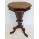 A 19th century octagonal walnut work-table with chessboard top: hinged lid opening to reveal varying