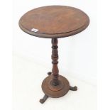A mid-19th century circular-topped walnut occasional table; turned stem and circular platform base