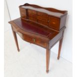 A reproduction lady's writing desk: the three-quarter galleried superstructure with six central