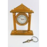 A late 19th/early 20th century gilt bronze miniature mantle clock: the cream enamel dial with Arabic