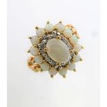 A 9 carat gold ring set with opals and white stones, size Q