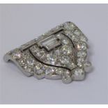 An Art Deco style multi-diamond mounted white metal clip brooch: a horizontal piercing above two