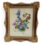 A gilt-framed ceramic plaque very finely decorated in enamels with a floral spray: signed ERNEST