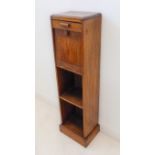 An early 20th century oak smoker's cabinet of slim proportions: single full-width top ashtray drawer