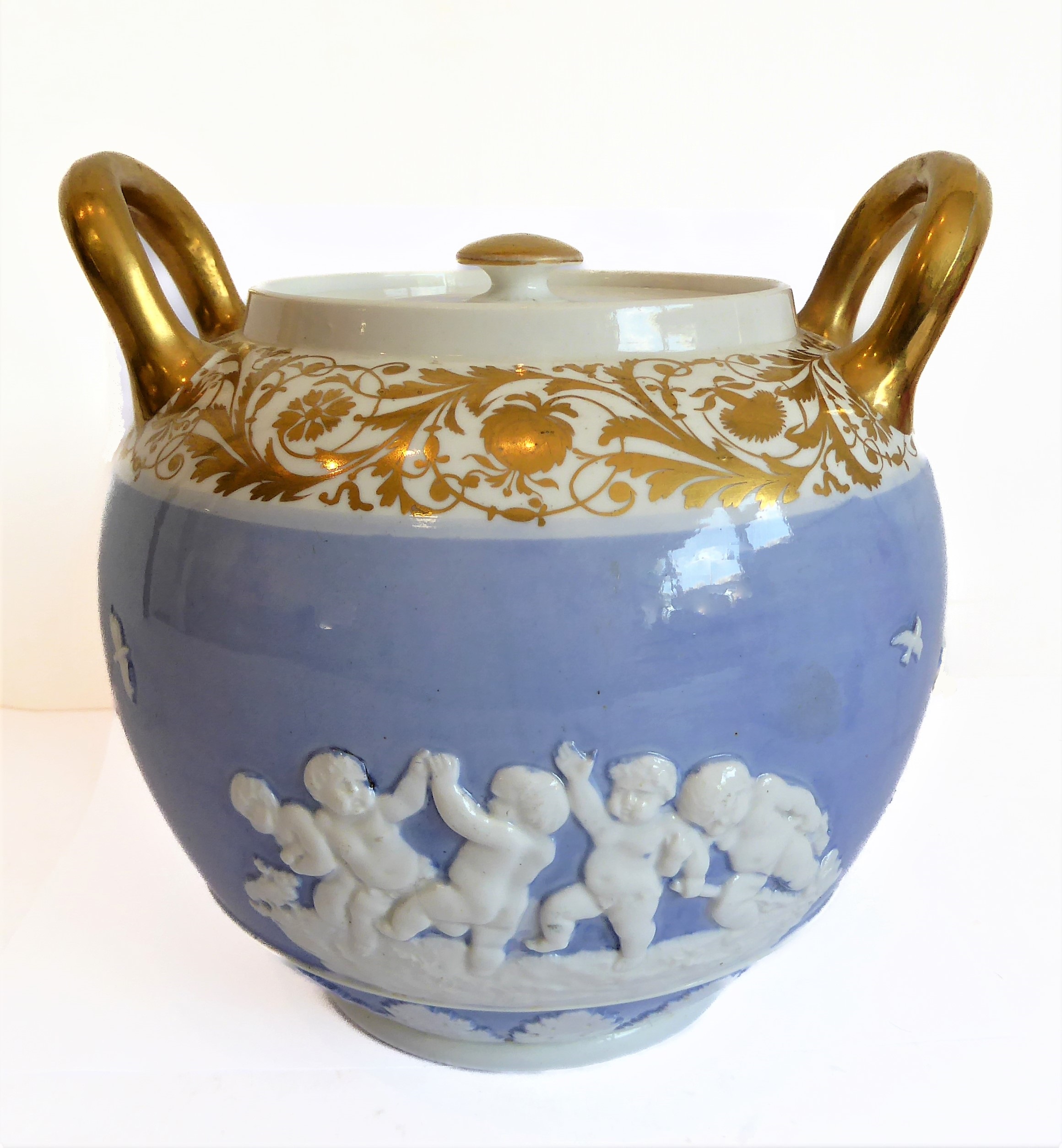 An early 19th century Spode two-handled ovoid pot and cover: gilded handles and a band of further